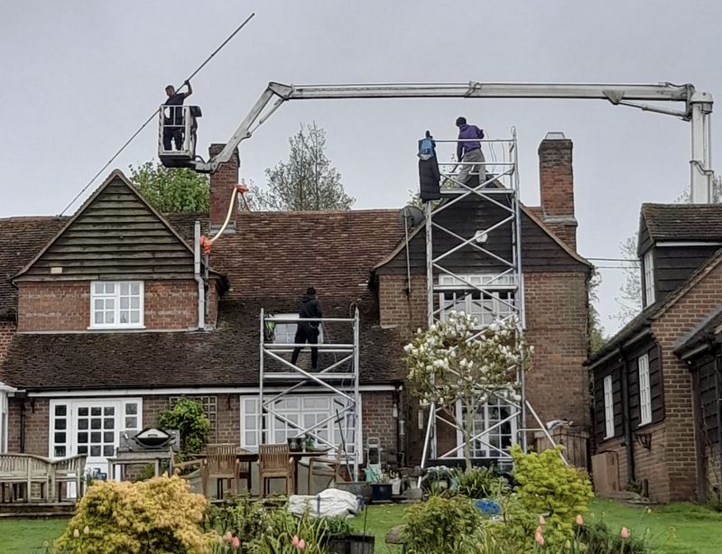 The Roof Moss Cleaners using cherry picker and scaffolding to clean roof safely and professionally in Hungerford, Berkshire